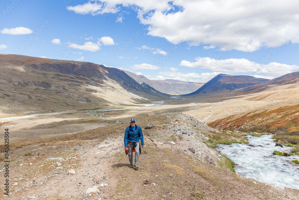Tourist climbs uphill. The nature of Mongolia
