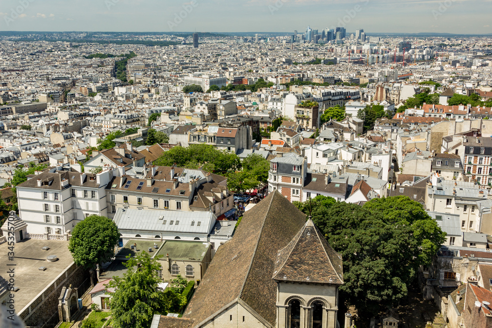 PARIS, FRANCE - JUNE 23, 2016: Aerial view of church of Saint Pierre de Montmartre from Basilica of the Sacred Heart of Jesus stands at the summit of the butte Montmartre - highest point in the Paris