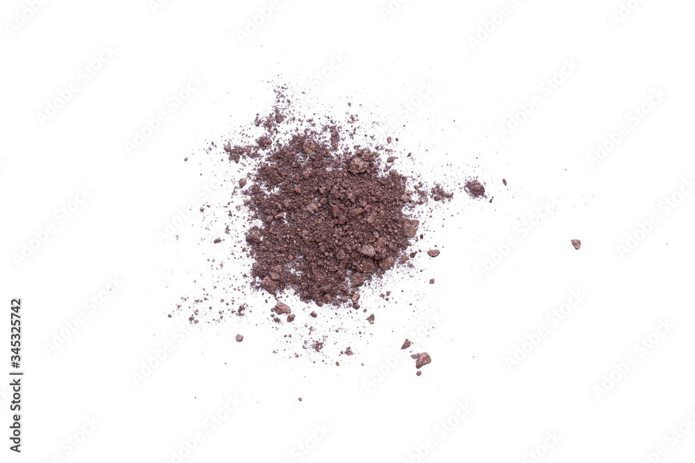 Deep brown crumbled eye shadow isolated on white background.Splatter make up and cosmetic products. Deep brown crumbled eye shadow isolated on white background.Splatter make up and cosmetic products.