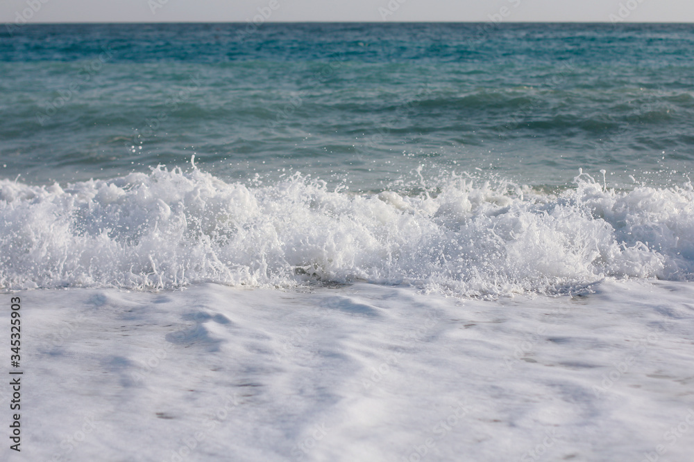 Big breaking wave on a sandy beach, Turkey