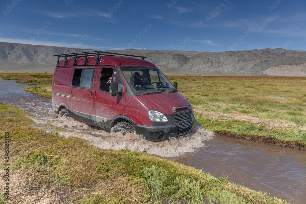 Journey of river on SUV car. Mongolia - Altai. photo made from inside car Journey of river on SUV car. Mongolia - Altai. photo made from inside car