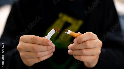 a boy breake down cigarette.Quitting from addiction concept.
