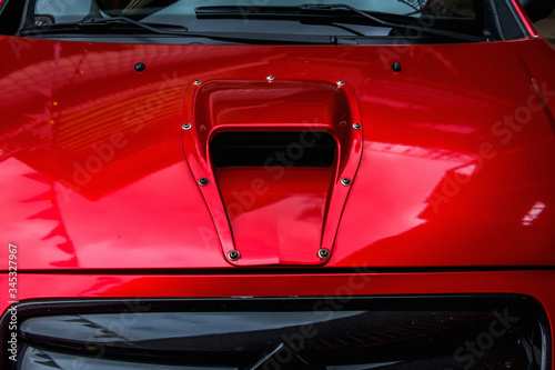 Hood with air intake close-up. Exclusive tuned car at the automobile exhibition. © Artemy Sobov