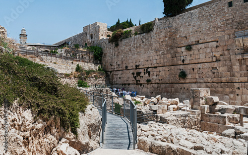 the southern section of the kotel western wall of the second temple showing people praying in the egalitarian section among the rubble from the roman destruction of jerusalem