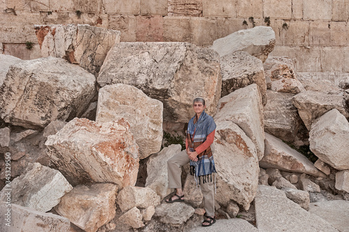 a female rabbi posing on the massive stones thrown down from the temple mount by the romans during the great jewish revolt in Jerusalem photo