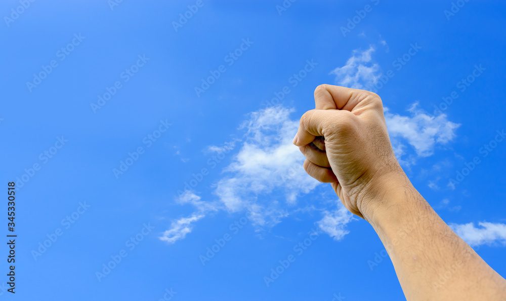the man raised his hand in the sky, showing strength. power and inspiration concept. fighting Covid-19 (corona virus) 02 the man raised his hand in the sky, showing strength. power and inspiration concept. fighting Covid-19 (corona virus) 02