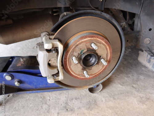 Car rear disc brake with caliper brake pad on maintenance and inspection.