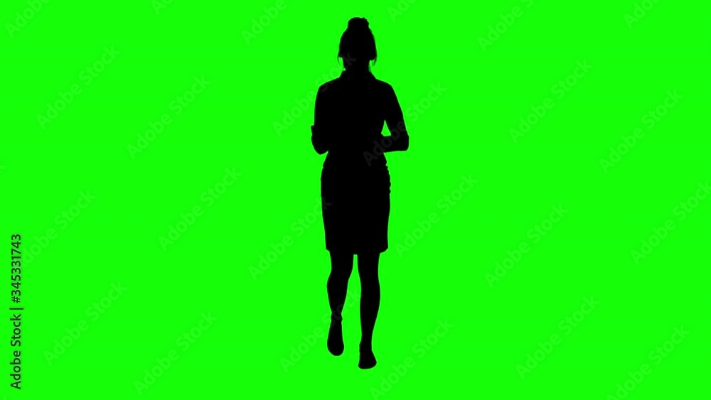 Businesswoman is Making Notes on a Clipboad Walking Green Screen Silhouette Businesswoman is Making Notes on a Clipboad Walking Green Screen Silhouette