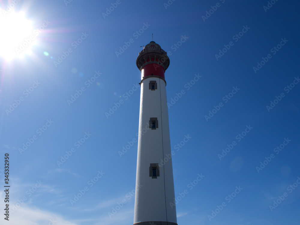 Ouistreham, normandy, France, A lighthouse against a blue sky Ouistreham, normandy, France, A lighthouse against a blue sky