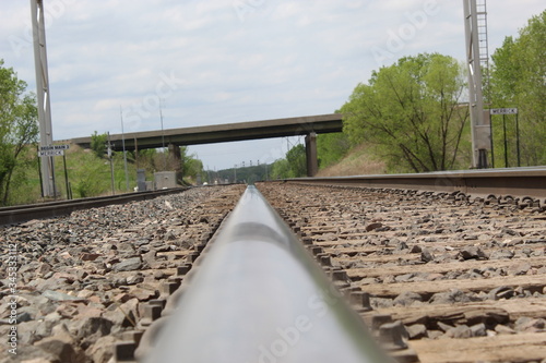 Shot of a single railroad track with a bridge in background
