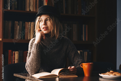 Girl reads a book in the library