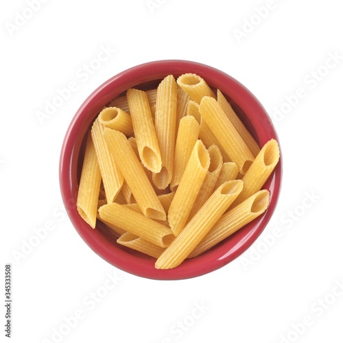 Penne Rigate noodles in a red bowl Isolated on white background. 