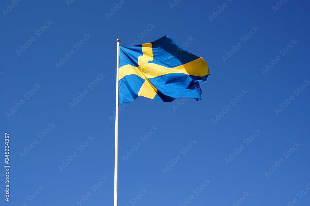 Sweden flag waving against the clear blue sky Sweden flag waving against the clear blue sky