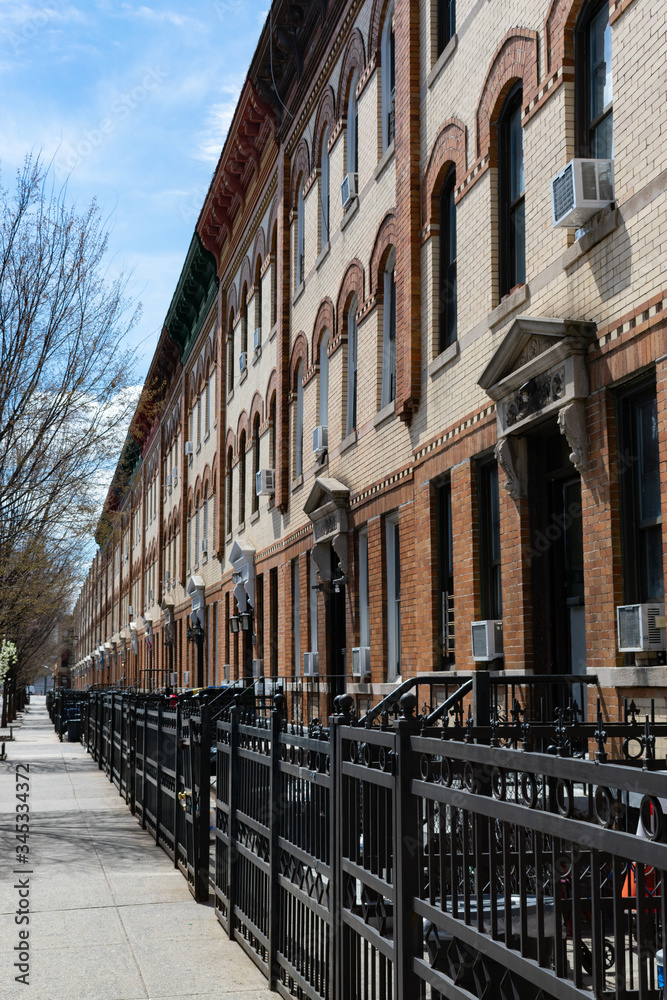 Row of Similar Apartment Buildings along an Empty Sidewalk in Astoria Queens New York