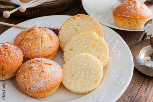 Homemade vanilla muffins sprinkled with icing sugar, selective focus