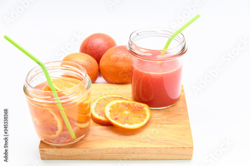 Jars of orangeade and homemade red orange juice