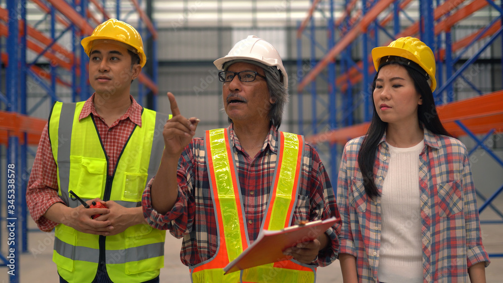 warehouse workers checking the shipment while working warehouse workers checking the shipment while working
