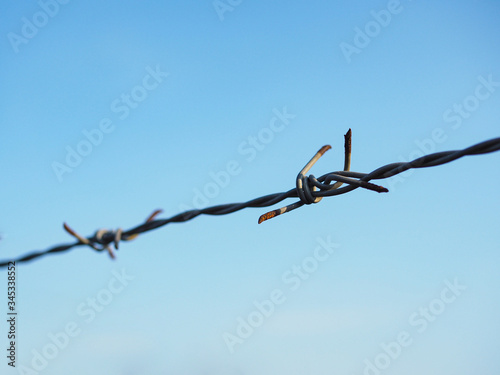 Barbed wire for enclosed areas.The rust on Barbed Wire.Wire Mesh And Sky.