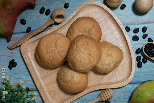 Tasty buttery buns on  wooden table