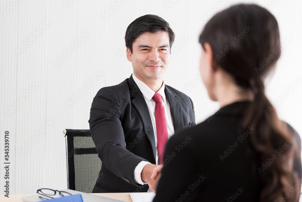 A businessman finish and handshake to candidate woman answers for a job interview. A businessman finish and handshake to candidate woman answers for a job interview.