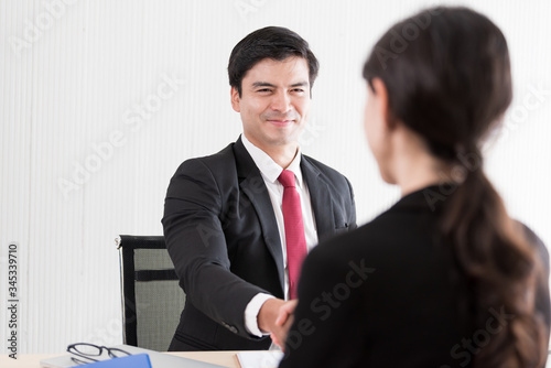 A businessman finish and handshake to candidate woman answers for a job interview.