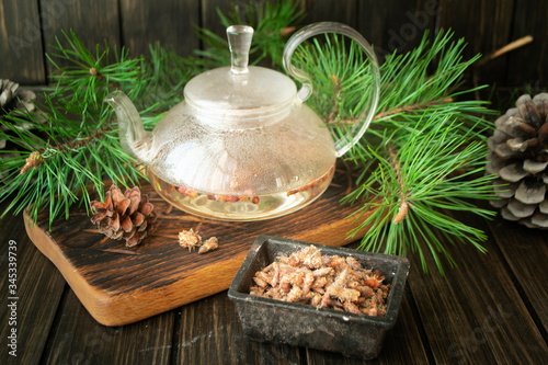 medicinal decoction with pine buds in glass teapot
