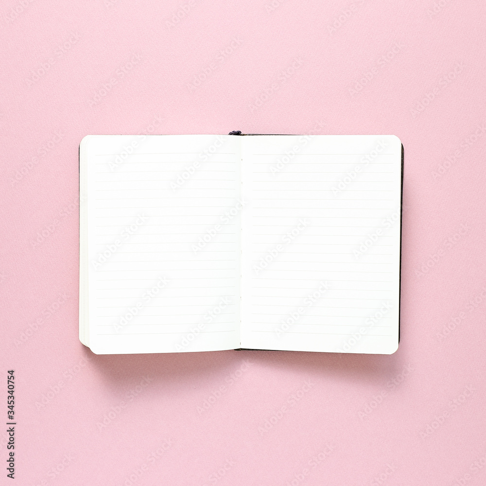 Empty notebook on pink background. top view, copy space Empty notebook on pink background. top view, copy space