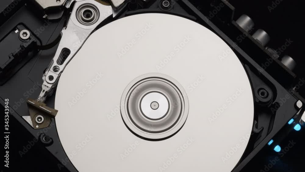 Macro, Close-Up of Computer Hard Disk Drive Spinning and Writing. Blue Lights Blinking. 4k Macro, Close-Up of Computer Hard Disk Drive Spinning and Writing. Blue Lights Blinking. 4k