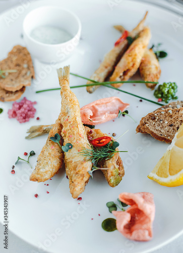 Grilled fish on plate isolated on white background