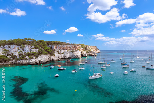 Fototapeta Naklejka Na Ścianę i Meble -  View of the most beautiful bay Cala Macarella of the island Menorca with emerald water and a lot of yachts on the sea. Balearic islands, Spain