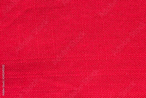 red cotton texture rough fabric background natural fabric and dye, bright red color. Top view. Flat lay composition