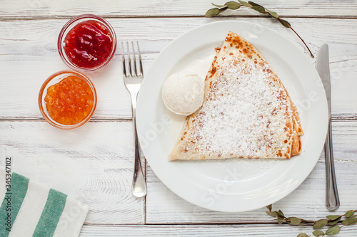 thin pancakes with jam honey and sour cream and coffee