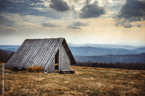 Old wooden shelter in mountain carpathian landscape Brenna Poland photo