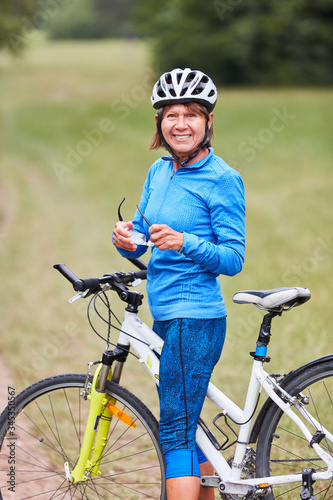 Sporty senior woman with a mountain bike