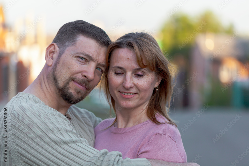 Happy married couple standing together on the street, tenderly holding hands. Happy married couple standing together on the street, tenderly holding hands.