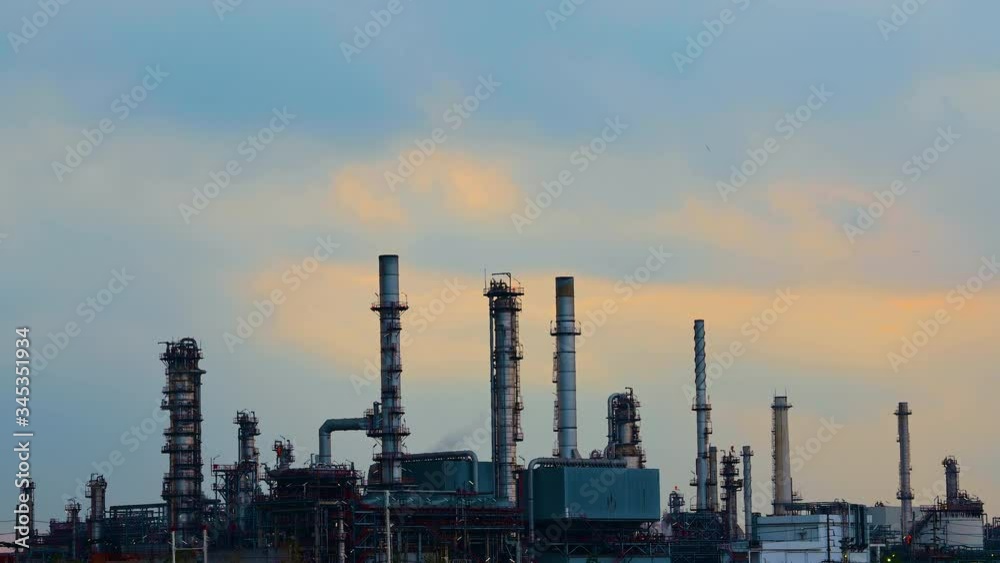 time lapse,oil refinery industry plant in twilight with a reflection in the river. Bangkok Thailand. time lapse,oil refinery industry plant in twilight with a reflection in the river. Bangkok Thailand.