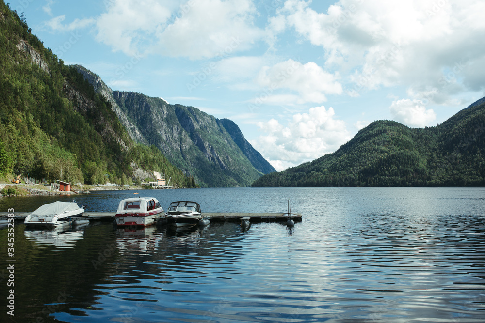 boats in pristan on a mountain river in norway
