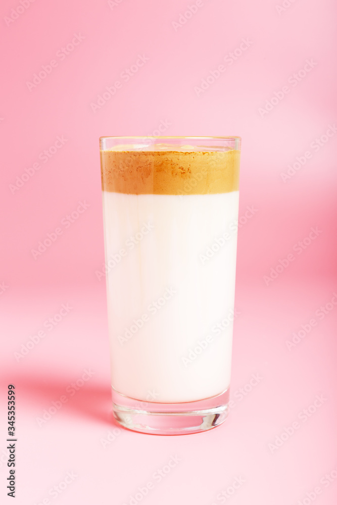 Dalgona coffee in a glass cup on a pink background. Minimalism, copy space Dalgona coffee in a glass cup on a pink background. Minimalism, copy space