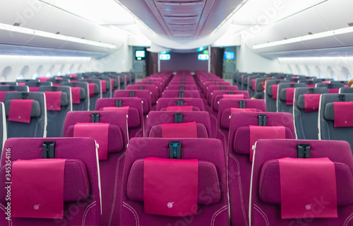 Empty aircraft cabin interior due to covid-19 medical global emergency pandemic. Transportation lockdown airline company economy default. No passenger on commercial plane.