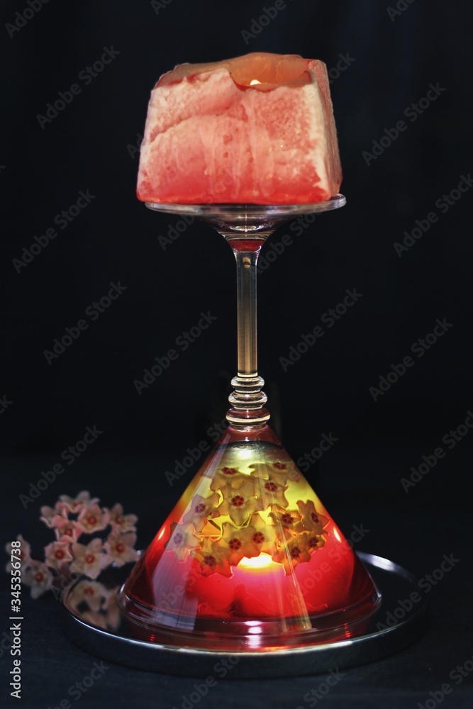 Sweet jelly dessert, design food, creative meals with vanilla flowers in dark mood on black background