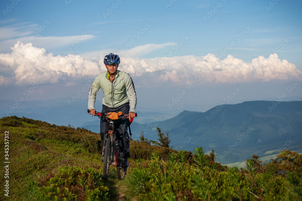 Woman rides bicycle in the beautiful green forest.