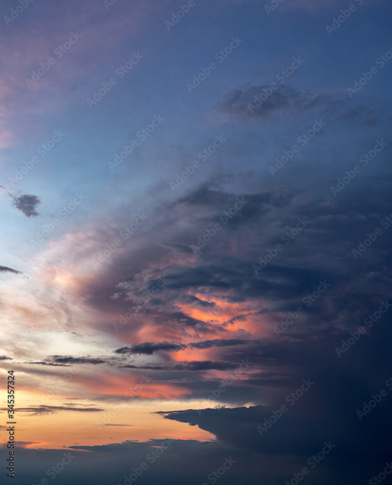 Image of the evening sky. Sunset. Beautiful clouds. Sunlight breaks through the clouds. Landscape