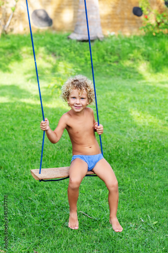 Happy Boy Swinging on a Swing