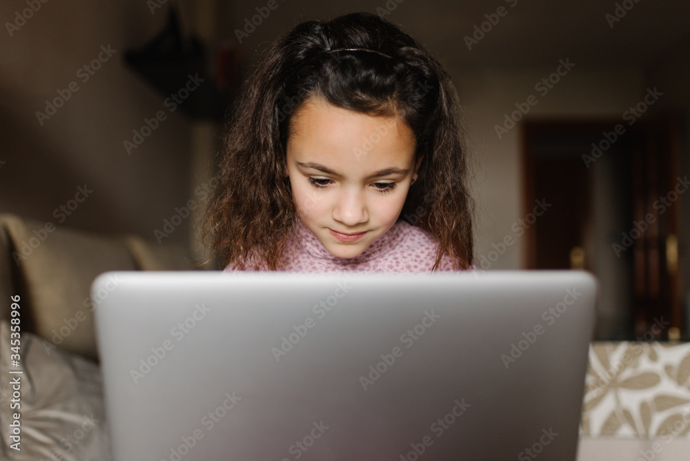 girl at home doing computer tasks girl at home doing computer tasks
