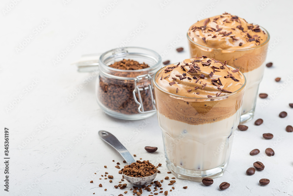 Trendy korean drink Dalgona coffee with ice, garnished with grated chocolate, light gray background, horizontal, copy space Trendy korean drink Dalgona coffee with ice, garnished with grated chocolate, light gray background, horizontal, copy space