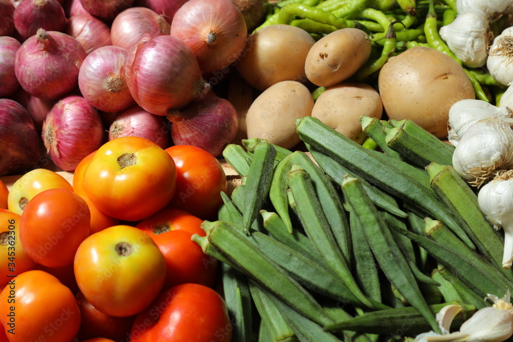 Indian Woman wearing gloves for hands consuming vegtables,indian market,asian vegetable market
