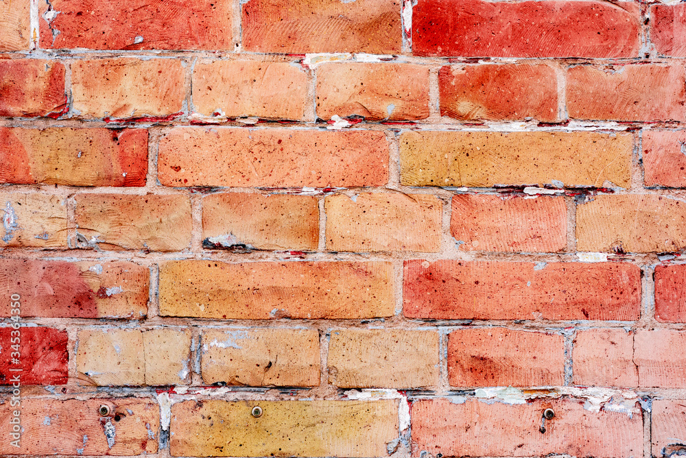 Texture of a brick wall with cracks and scratches which can be used as a background
