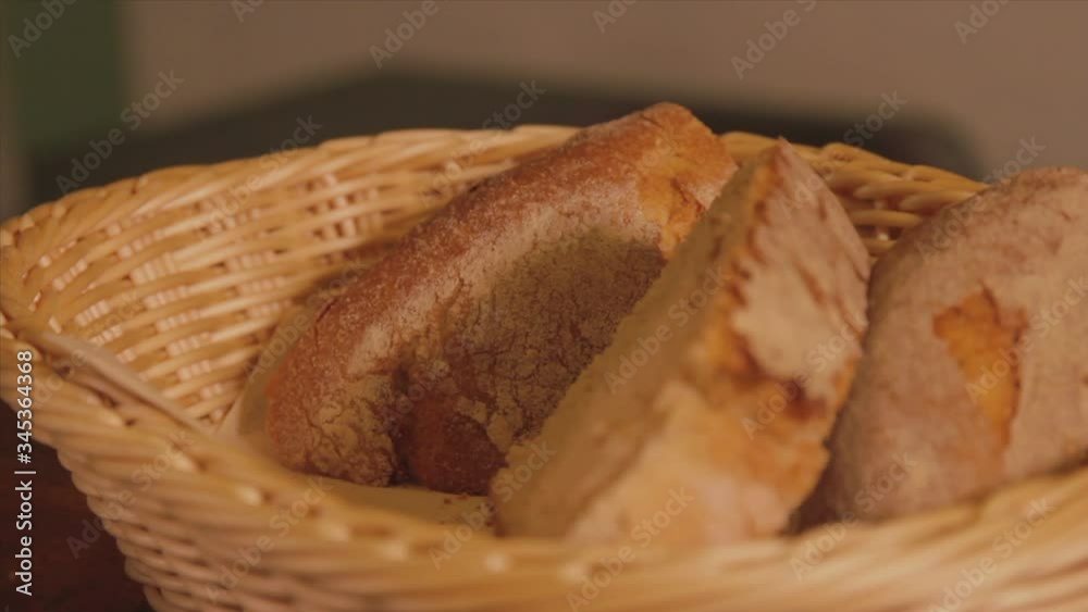 Detail placing the bread in the basket after cutting the waiter. Detail placing the bread in the basket after cutting the waiter.
