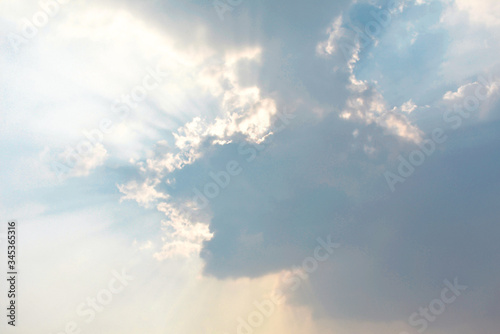 Beautiful rays of sunlight coming out of dark clouds in the sky