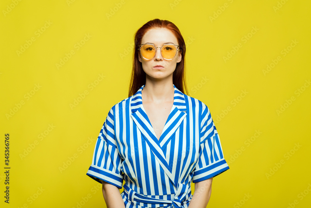 A girl with beautifull red hair on the yellow background. Stylish trending template for advertising A girl with beautifull red hair on the yellow background. Stylish trending template for advertising
